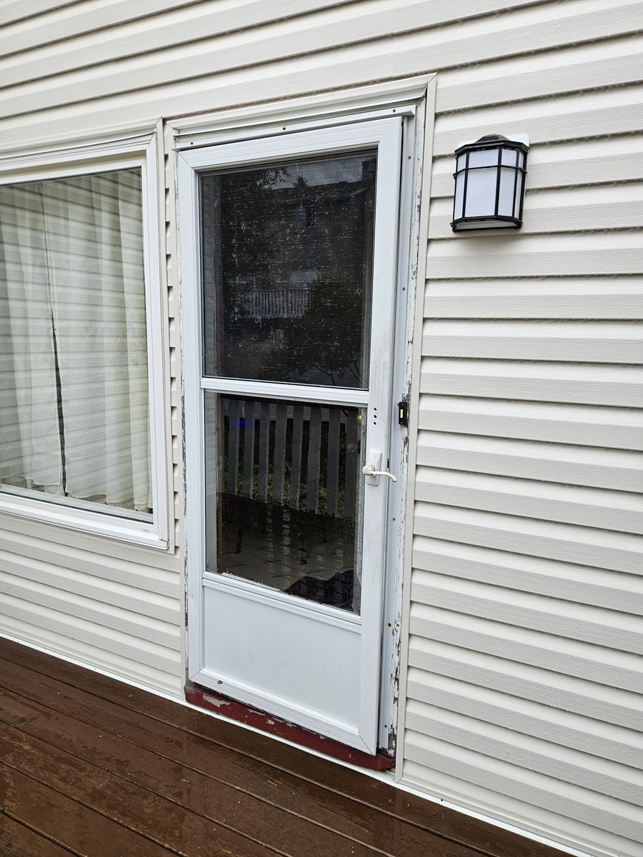 Old storm door with rotting kick plate