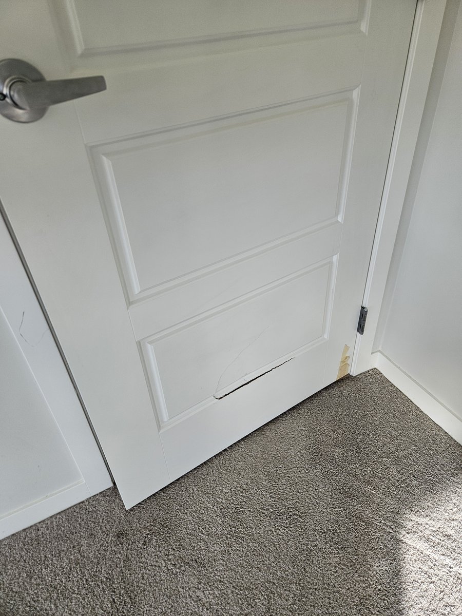 Broken interior slab door before replacement